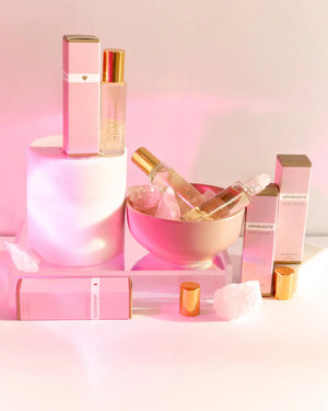 Light perfume with a heavenly blend of Ylang Ylang, Grapefruit Oil, Sweet Orange Oil, Patchouli and Mandarin Oil. displayed with a pink background.