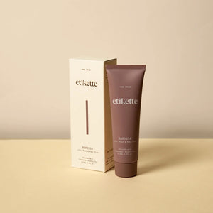 A tube of Barossa hand cream next to its white cardboard packaging box, set on a light beige surface against a neutral cream background.