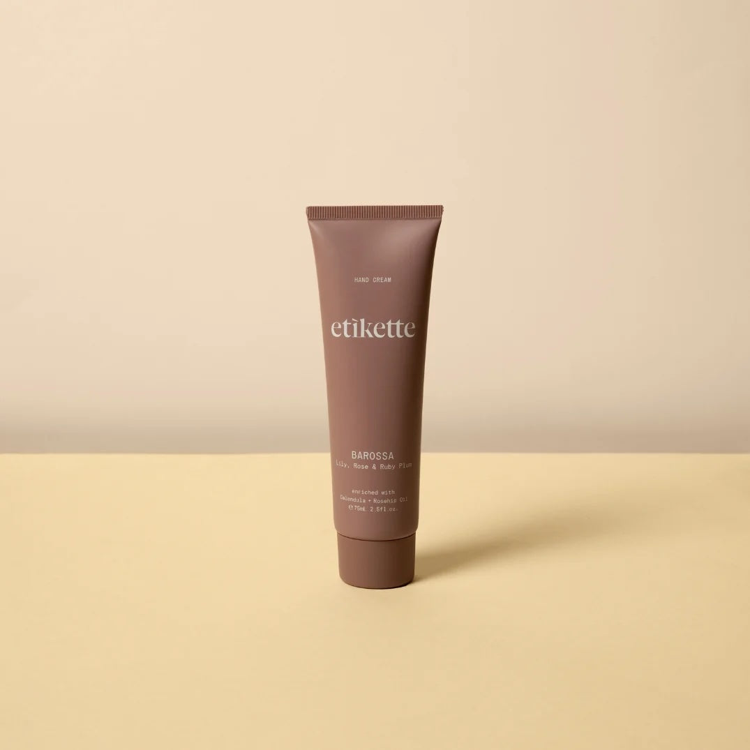 A single tube of Barossa Hand Cream standing upright on a light beige surface against a matching beige background.
