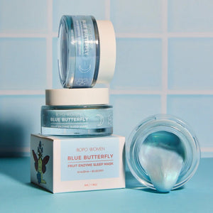 Blue Butterfly fruit enzyme sleep mask with packaging on a blue tiled background