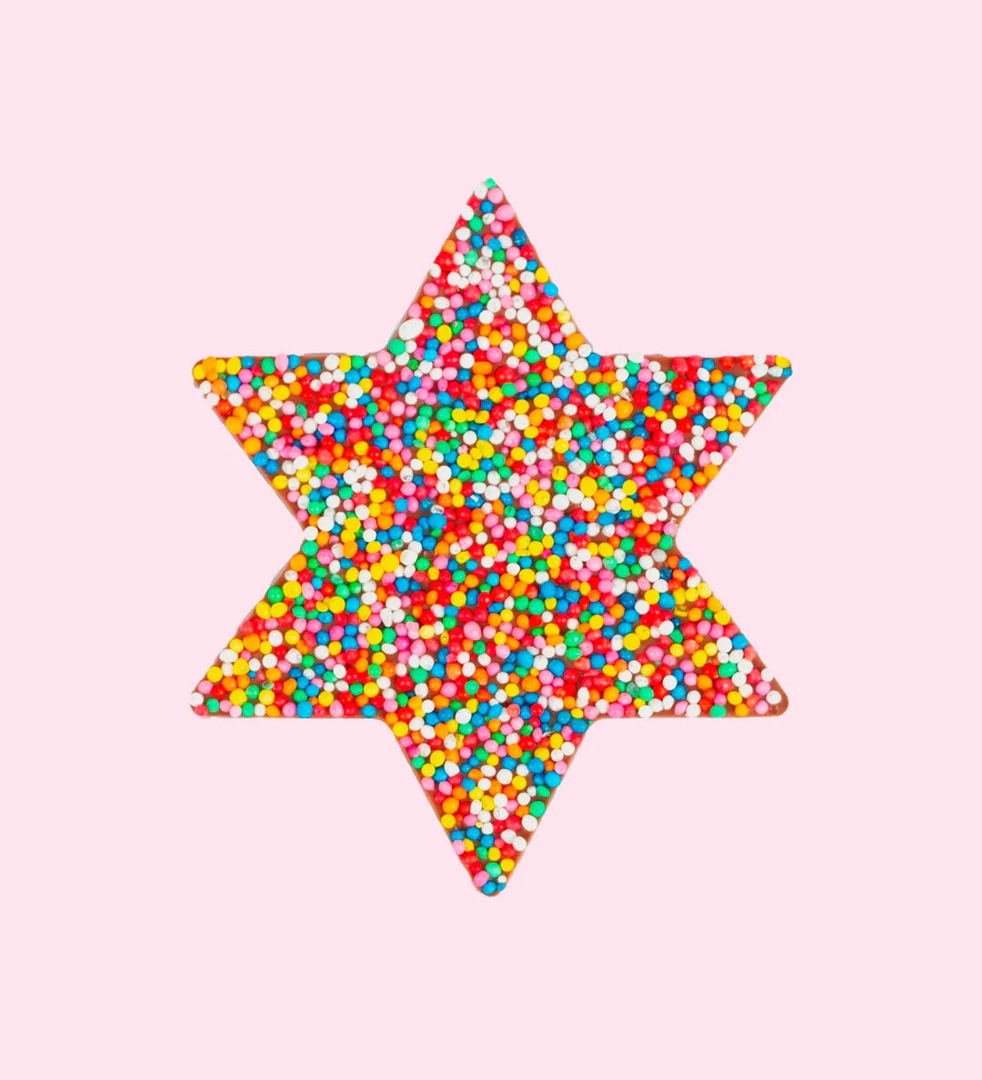 chocolate star covered in freckles on a pink background