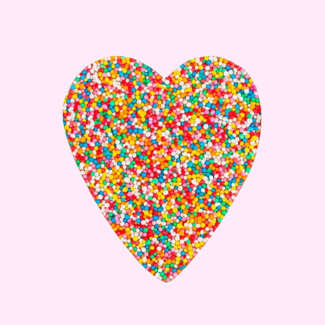 Chocolate freckle heart-shape on a light pink background
