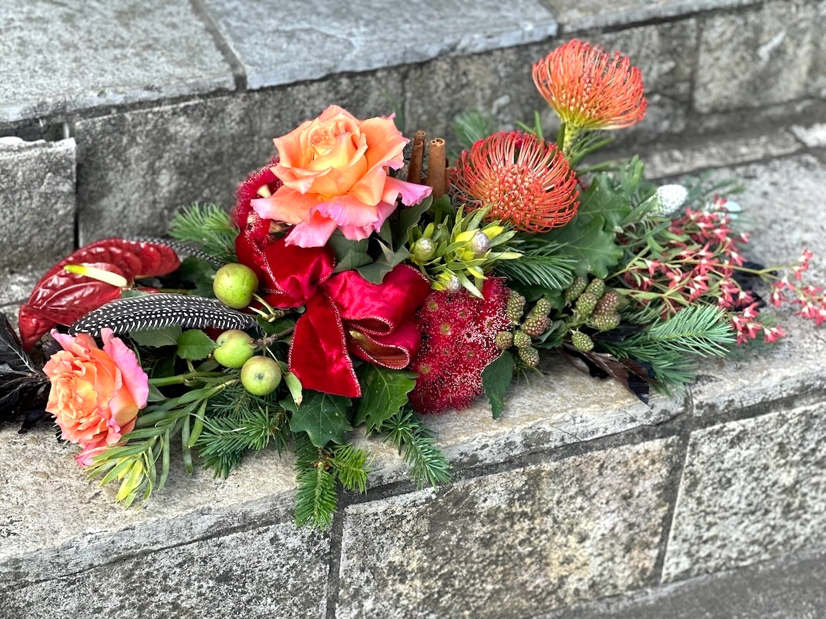 Floral table arrangement with pink and white flowers on a textured surface