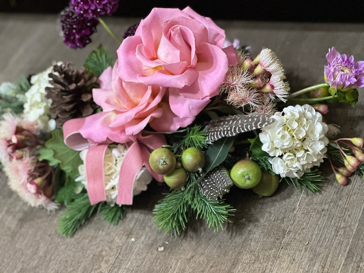 Floral table arrangement with pink and white flowers on a textured surface