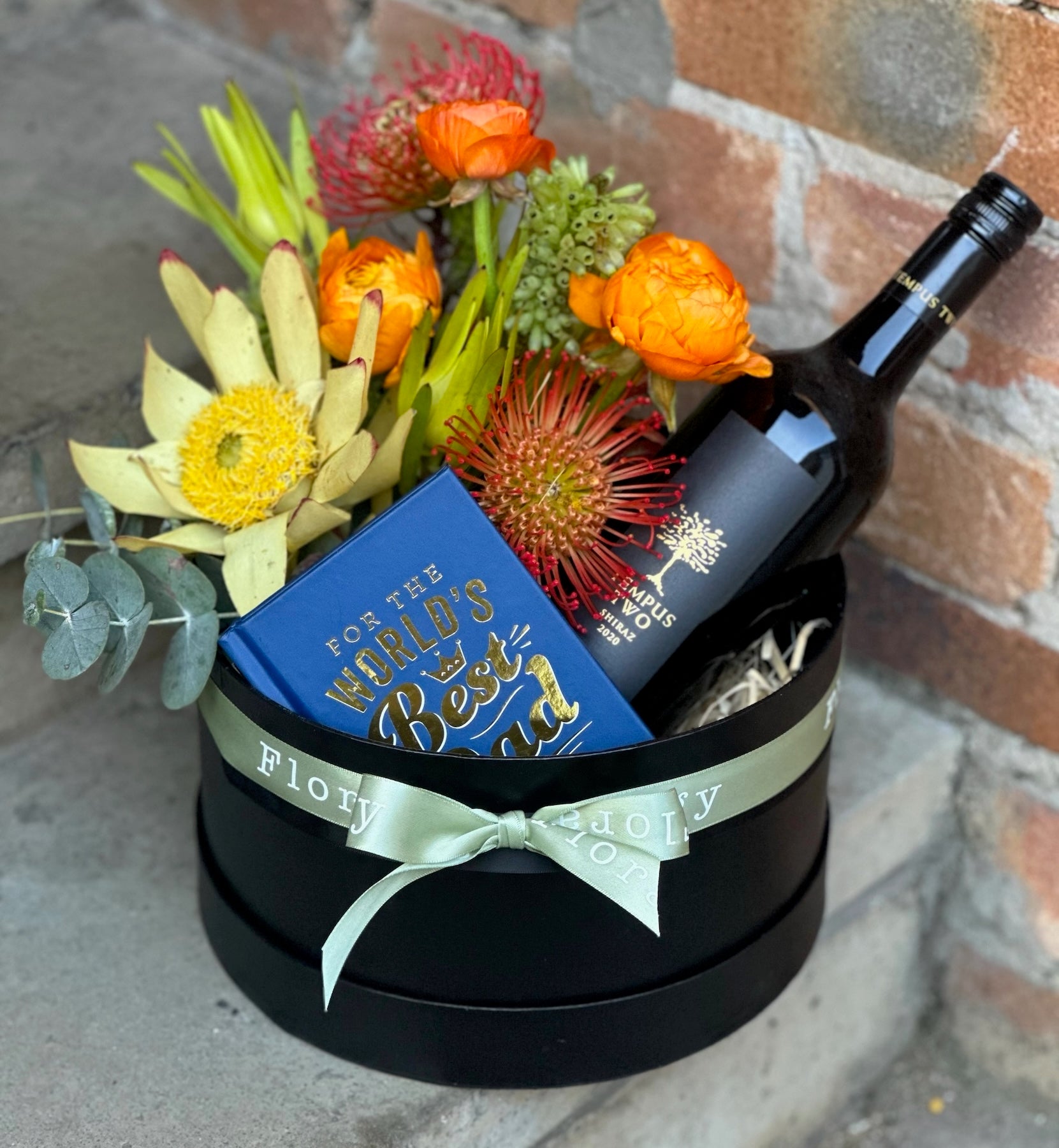 A Father's Day Hamper with arrangement of native flowers and a bottle of red wine.