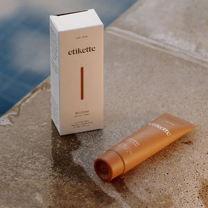 tube of Wilpena hand cream on a tiled poolside next to a white packaging box.