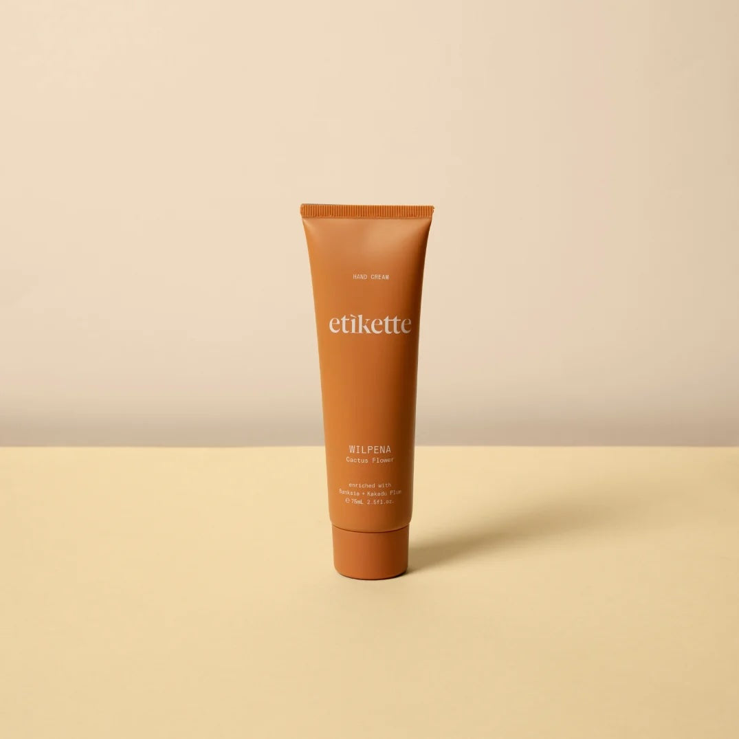 Tube of Wilpena hand cream against a yellow and beige background.