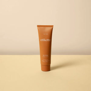 Tube of Wilpena hand cream against a yellow and beige background.