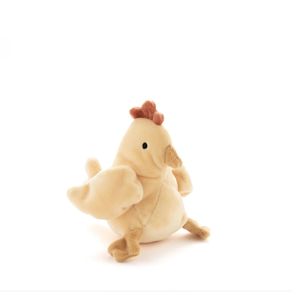 Honey coloured  soft toy chicken rattle in plush fabric on a white background.