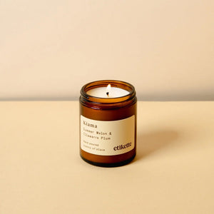 Kiama scented 175ml candle in a brown glass jar with a label on a beige background