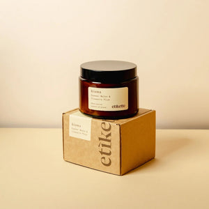 Kiama double wick 500ml Candle in a brown glass jar and packaging in a brown cardboard box . 