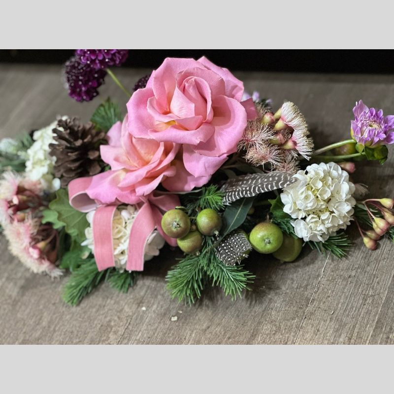 christmas table arrangement with pink and white blooms