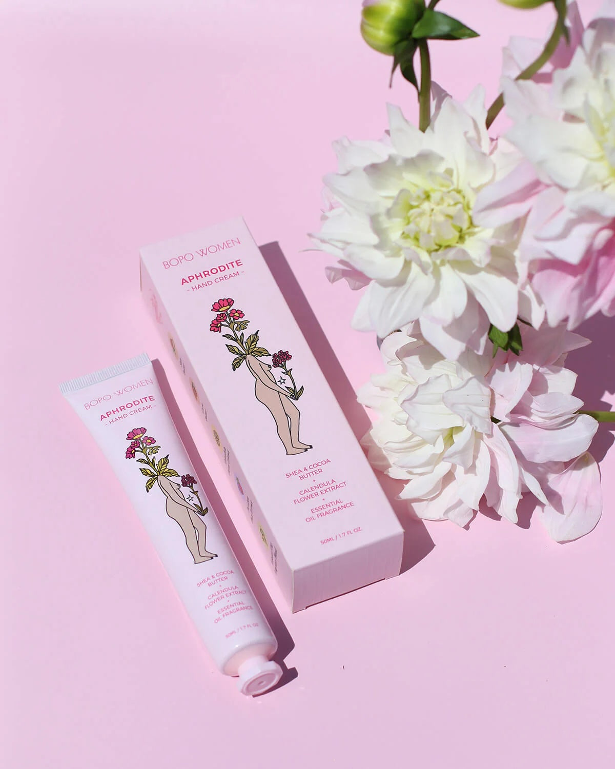 Luxury hand cream, with Davidson Plum an Australian botanical and 100% essential oils. Packaging on a pink background with flowers.