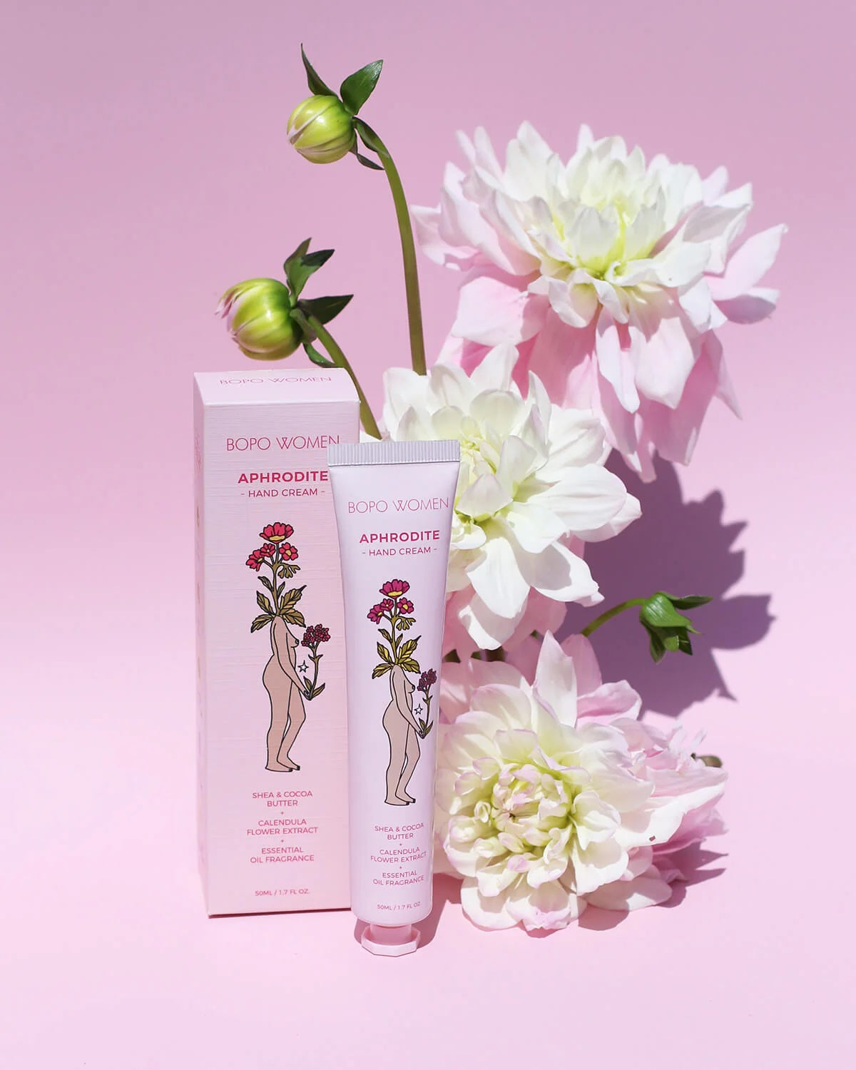 Luxury hand cream, with Davidson Plum an Australian botanical and 100% essential oils. Packaging on a pink background with flowers.