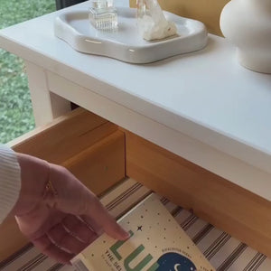 video of a woman with taking a self-warming eye mask being out of a drawer, opening it and placing it on her eyes.