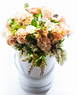 A selection of seasonal flowers styled and arranged in a Botanical Hat Box. 