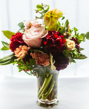 Complement your blooms with a glass vase. A bouquet of flowers presented in a reusable clear glass vase.