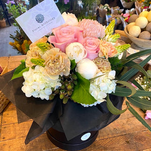 A stylish and impressive selection of seasonal flowers styled and arranged in a Botanical Hat Box. No need for a vase as the flowers sit in a bucket inside the Hat Box.